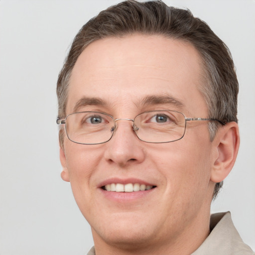 Joyful white adult male with short  brown hair and grey eyes