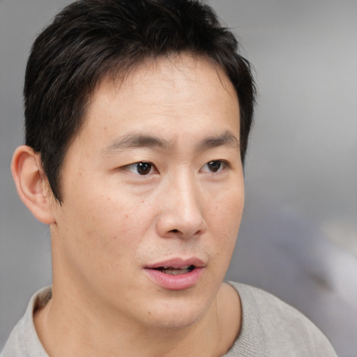 Neutral asian young-adult male with short  brown hair and brown eyes