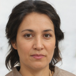 Joyful white adult female with medium  brown hair and brown eyes