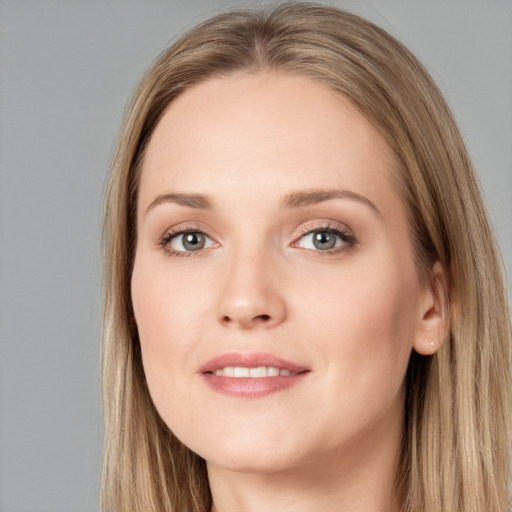 Joyful white young-adult female with long  brown hair and blue eyes