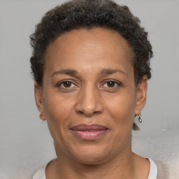 Joyful black adult female with short  brown hair and brown eyes