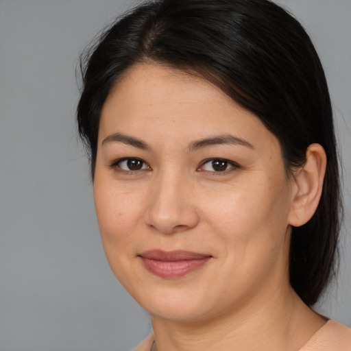 Joyful asian young-adult female with medium  brown hair and brown eyes
