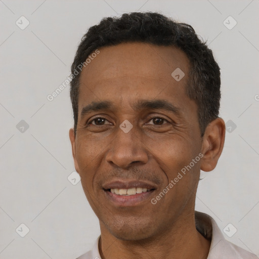 Joyful black adult male with short  black hair and brown eyes