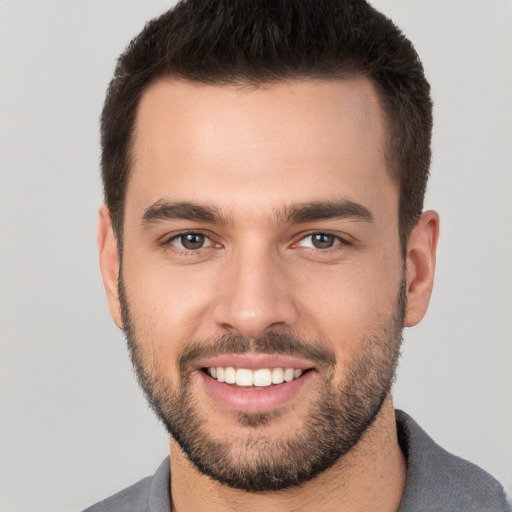 Joyful white young-adult male with short  brown hair and brown eyes