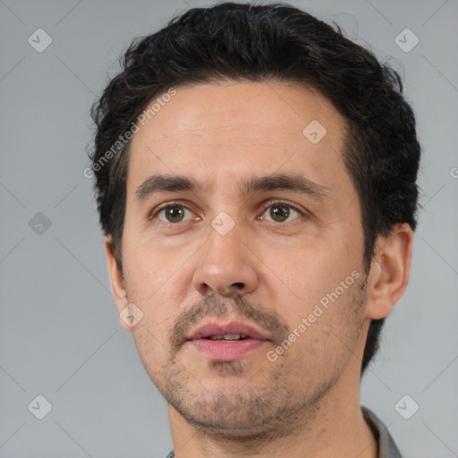 Neutral white adult male with short  black hair and brown eyes