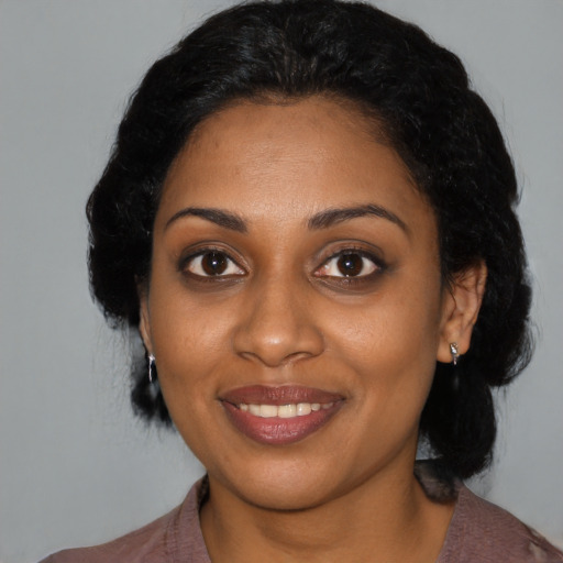 Joyful black young-adult female with medium  black hair and brown eyes