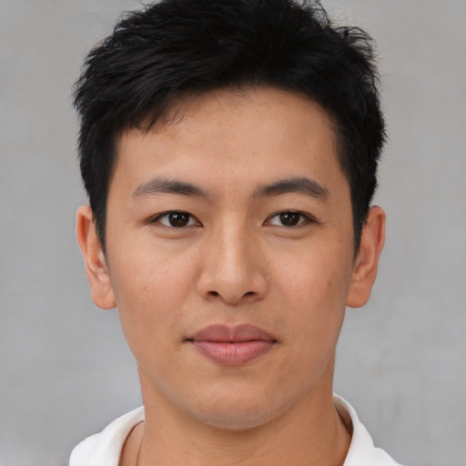 Joyful asian young-adult male with short  black hair and brown eyes