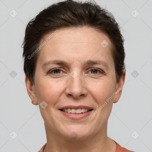 Joyful white adult female with short  brown hair and brown eyes