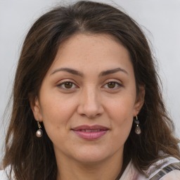 Joyful white adult female with medium  brown hair and grey eyes