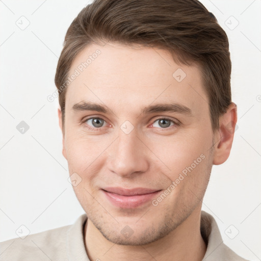 Joyful white young-adult male with short  brown hair and grey eyes