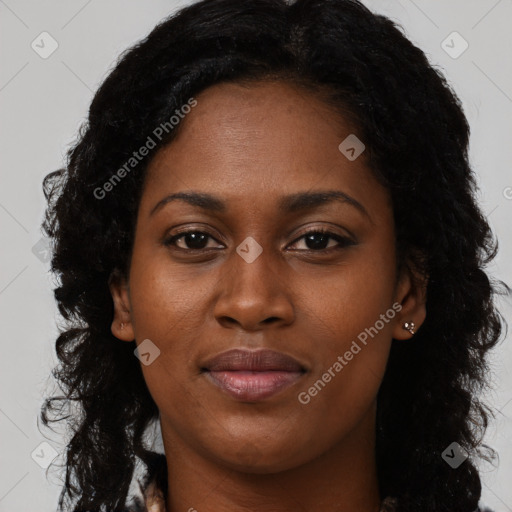 Joyful black young-adult female with long  black hair and brown eyes