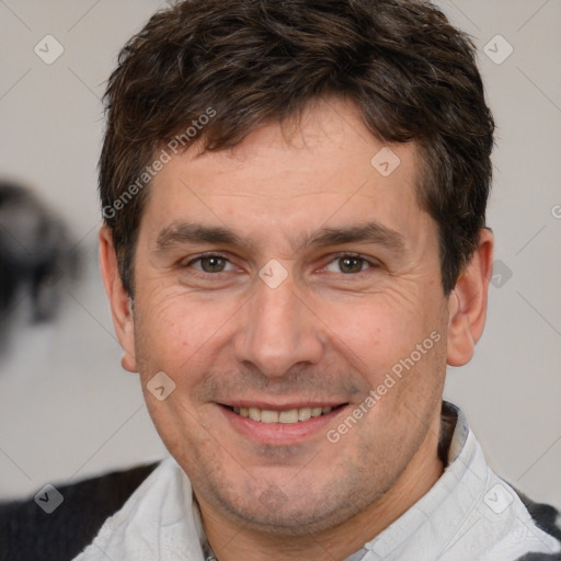 Joyful white adult male with short  brown hair and brown eyes