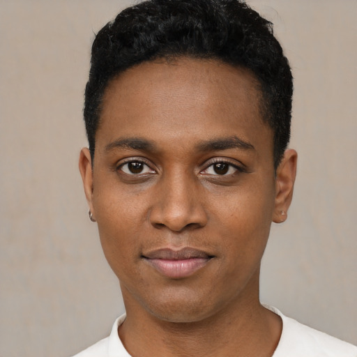 Joyful black young-adult male with short  black hair and brown eyes