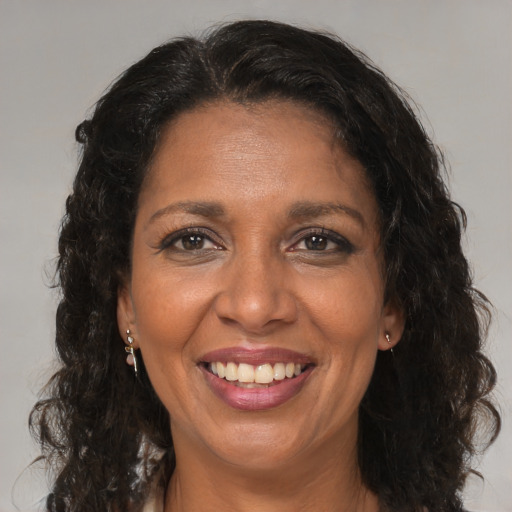 Joyful black adult female with medium  brown hair and brown eyes