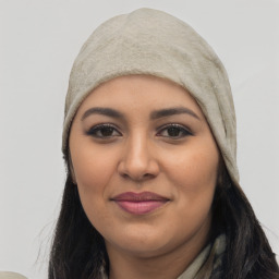 Joyful white young-adult female with long  black hair and brown eyes