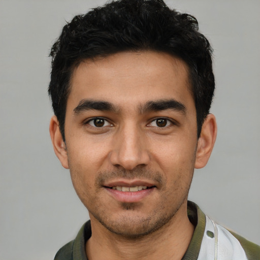 Joyful white young-adult male with short  black hair and brown eyes