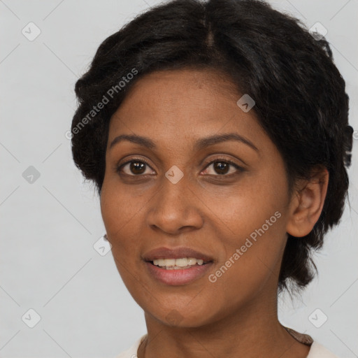 Joyful black adult female with short  brown hair and brown eyes