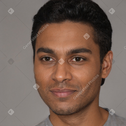 Joyful black young-adult male with short  black hair and brown eyes