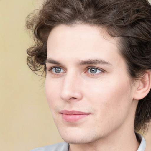 Joyful white young-adult male with medium  brown hair and grey eyes