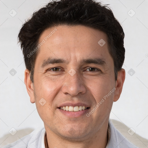 Joyful white adult male with short  brown hair and brown eyes