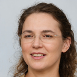 Joyful white adult female with medium  brown hair and brown eyes