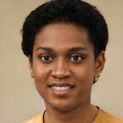 Joyful black young-adult female with short  brown hair and brown eyes