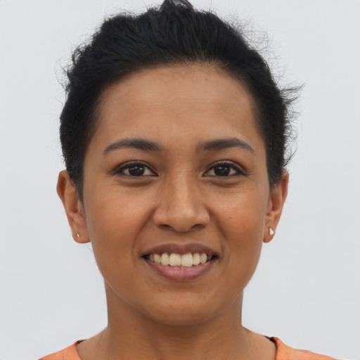 Joyful latino young-adult female with short  black hair and brown eyes