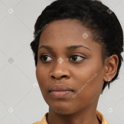 Joyful black young-adult female with short  brown hair and brown eyes