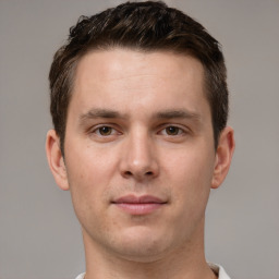 Joyful white young-adult male with short  brown hair and grey eyes