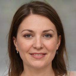 Joyful white adult female with medium  brown hair and grey eyes