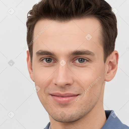 Joyful white young-adult male with short  brown hair and grey eyes