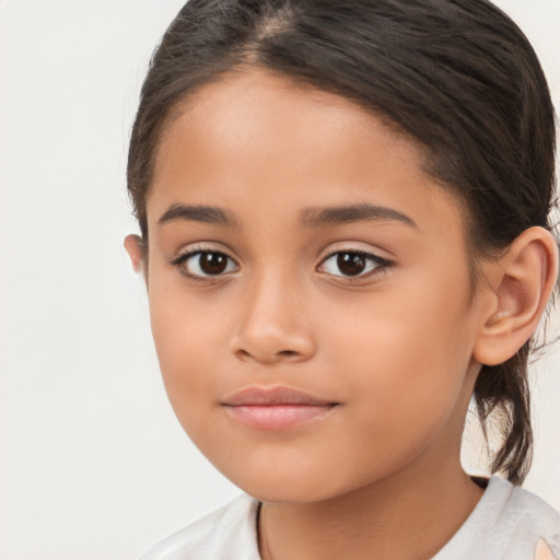 Joyful white child female with long  brown hair and brown eyes