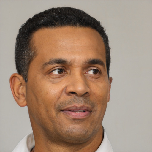 Neutral black adult male with short  black hair and brown eyes