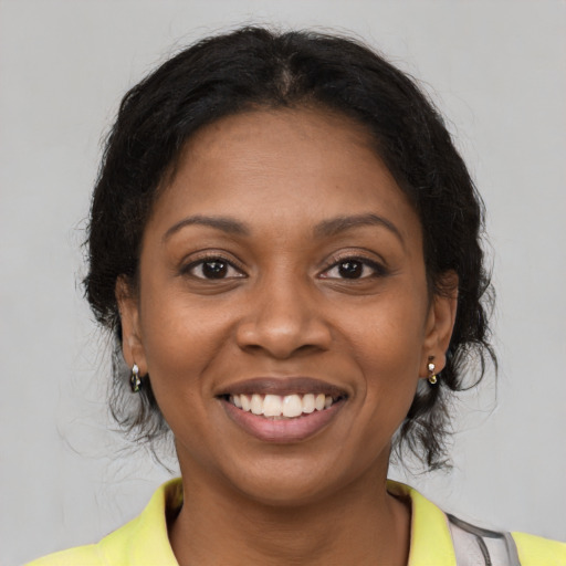 Joyful black young-adult female with medium  brown hair and brown eyes