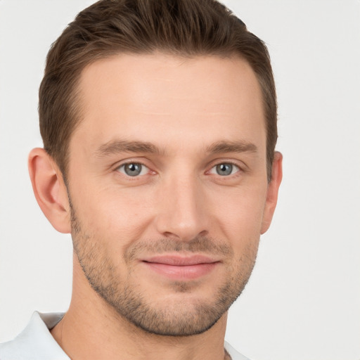 Joyful white young-adult male with short  brown hair and grey eyes