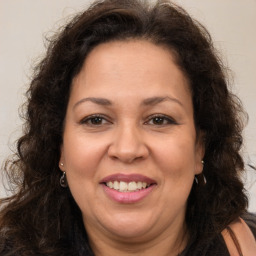 Joyful white adult female with long  brown hair and brown eyes