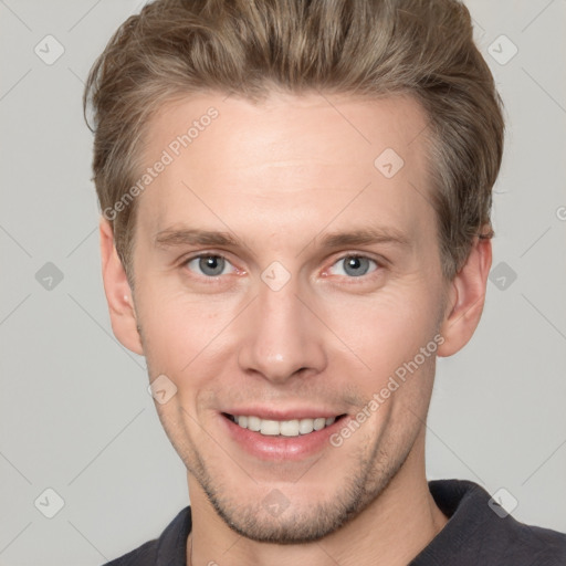 Joyful white young-adult male with short  brown hair and grey eyes