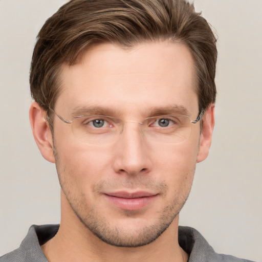 Joyful white young-adult male with short  brown hair and grey eyes