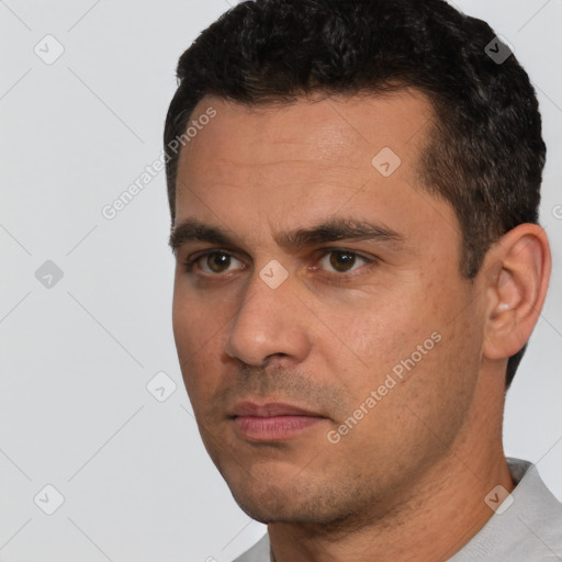 Joyful white young-adult male with short  black hair and brown eyes