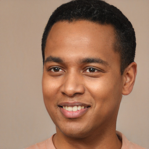 Joyful black young-adult male with short  brown hair and brown eyes