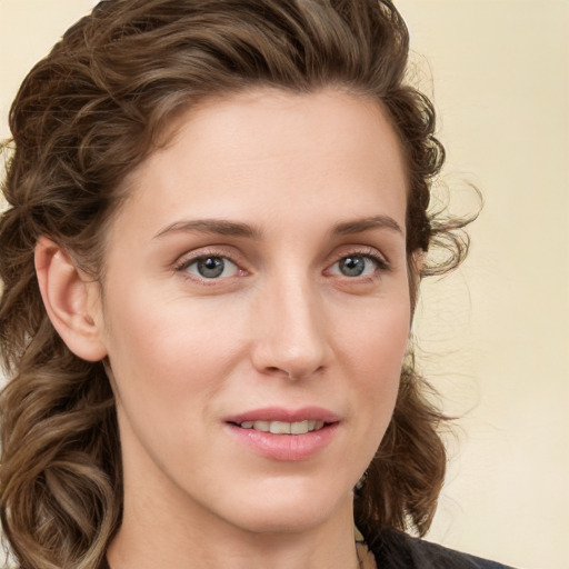 Joyful white young-adult female with medium  brown hair and green eyes