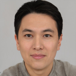 Joyful asian young-adult male with short  black hair and brown eyes