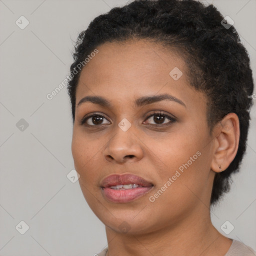 Joyful black young-adult female with short  black hair and brown eyes