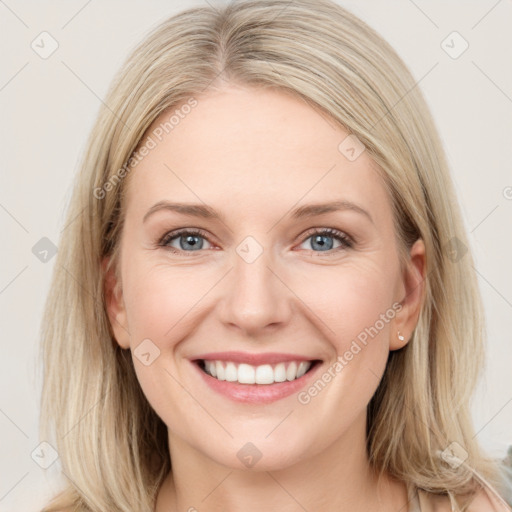 Joyful white young-adult female with medium  brown hair and blue eyes