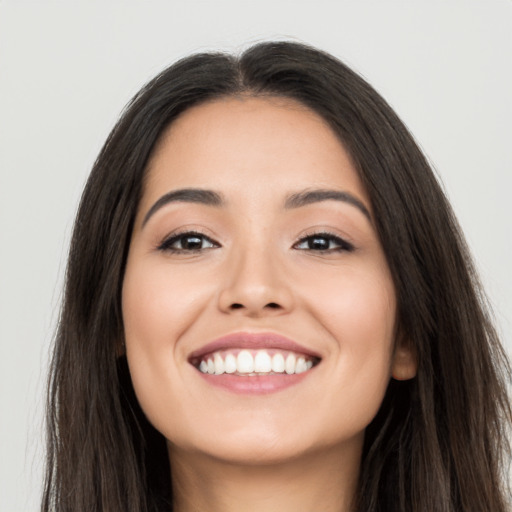 Joyful white young-adult female with long  black hair and brown eyes