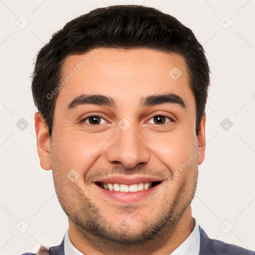 Joyful white young-adult male with short  black hair and brown eyes