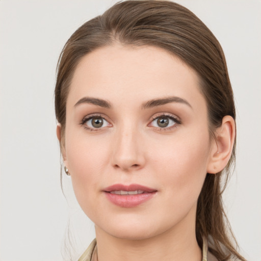 Joyful white young-adult female with medium  brown hair and grey eyes