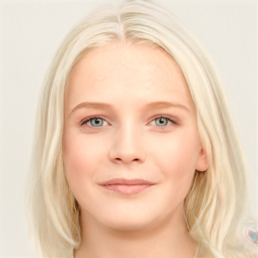 Joyful white young-adult female with long  blond hair and blue eyes