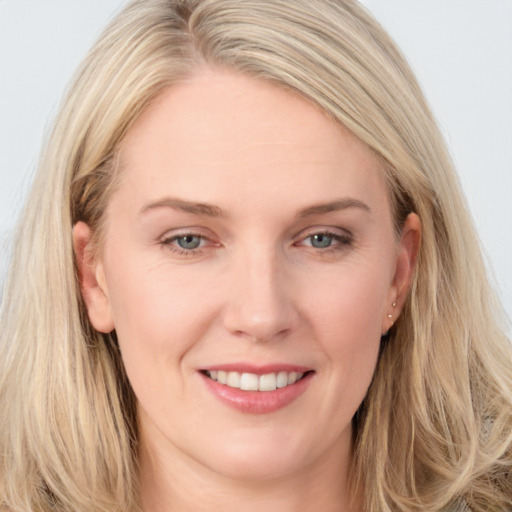 Joyful white young-adult female with long  brown hair and blue eyes