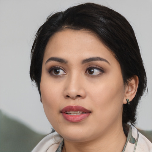 Joyful asian young-adult female with medium  black hair and brown eyes